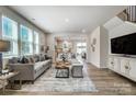 Inviting living room with hardwood floors and large windows, flowing into the dining and kitchen area at 2310 Hedgecliff Rd # 159, Kannapolis, NC 28025