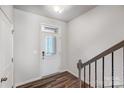 Bright entryway featuring a white front door, hardwood floors, and staircase with wrought iron railing at 2320 Hedgecliff Rd # 158, Kannapolis, NC 28025