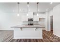 Modern kitchen with white cabinets, stainless steel appliances, granite countertops, and pendant lighting at 2320 Hedgecliff Rd # 158, Kannapolis, NC 28025