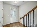Entryway features wood-look flooring, staircase with wooden railing, and a front door with glass accents at 2340 Hedgecliff Rd # 156, Kannapolis, NC 28025