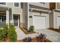 Close-up exterior view of a townhome featuring a one-car garage and covered entryway at 2340 Hedgecliff Rd # 156, Kannapolis, NC 28025