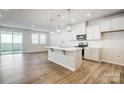 Open kitchen concept featuring an island, pendant lighting, stainless steel appliances, and wood-look flooring at 2340 Hedgecliff Rd # 156, Kannapolis, NC 28025