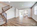 Open-concept living room features modern floors, ample lighting, and seamless flow to the kitchen at 2350 Hedgecliff Rd, Kannapolis, NC 28025