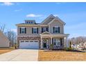 Charming two-story home with a stone and siding facade, a two-car garage, and a well-maintained front lawn at 245 Pine Eagle Dr, Rock Hill, SC 29732