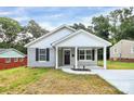 Charming home with a covered front porch, gray siding and black shutters at 265 Duke Dr, Salisbury, NC 28146