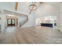 Spacious living room with hardwood floors, high ceilings, and staircase at 310 Sugar Maple Ln, Weddington, NC 28104