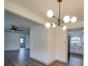 Open-concept dining area with modern chandelier, and easy access to kitchen and living room at 337 Glenwood Dr, Mooresville, NC 28115