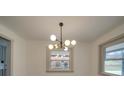 Dining room with modern chandelier and a window overlooking the front yard at 337 Glenwood Dr, Mooresville, NC 28115