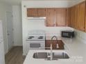 Bright kitchen with white countertops, oak cabinets, and modern stainless steel faucet at 351 Haigler St, Rock Hill, SC 29732