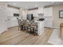 Bright kitchen featuring white cabinetry, stainless steel appliances, and a center island with seating at 508 Kenyon Dr, Denver, NC 28037