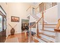 Grand foyer with hardwood floors, staircase, and high ceilings creating an inviting entrance at 5101 Belicourt Dr, Charlotte, NC 28277