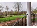 Scenic view from the porch showing a beautiful, well-maintained community green space at 599 Sixth Baxter Xing, Fort Mill, SC 29708