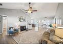 Bright living room featuring a fireplace, ceiling fan, and neutral color palette at 7200 Morning Dew Ct, Denver, NC 28037