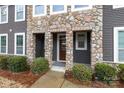 Inviting covered front porch with stone accents and a welcoming entrance mat at 1019 Archibald Ave, Fort Mill, SC 29708