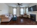 Comfortable living room with hardwood floors, a fireplace, and ample natural light at 1019 Archibald Ave, Fort Mill, SC 29708