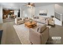Bright living room featuring neutral furniture, a ceiling fan and open access to kitchen at 111 Chaffee Pl, Mooresville, NC 28115