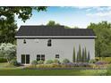 Rear exterior view features gray siding, trimmed garden beds, a sliding glass door and lush lawn at 1146 Nations Dr, Charlotte, NC 28217