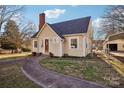 Charming cottage-style home with a brick chimney, quaint front yard, and inviting walkway at 148 Linwood Dr, Albemarle, NC 28001