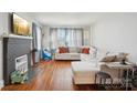 Cozy living room with hardwood floors, a gray painted fireplace, and a comfortable sectional sofa at 148 Linwood Dr, Albemarle, NC 28001
