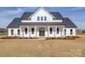 Beautifully crafted two-story home featuring a covered porch and pristine white facade at 1706 Ruben Rd, Monroe, NC 28112
