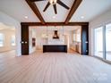 Open-concept living space with stylish beams and a seamless flow to the gourmet kitchen at 1706 Ruben Rd, Monroe, NC 28112