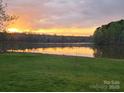 Scenic backyard with a lake view offers a tranquil and picturesque setting at sunset at 175 Riley'S Dr, Salisbury, NC 28146