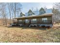 Inviting two-story home with a metal roof and a charming, spacious porch at 175 Riley'S Dr, Salisbury, NC 28146