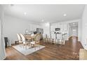 Bright kitchen with white cabinetry, stainless steel appliances, hardwood floors, and a large dining area at 1949 Vanderlyn St, Monroe, NC 28112