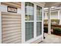 Close-up showcasing a tan home's siding, window details, and the house number at 2036 Hudson Ln, Fort Mill, SC 29707