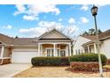 Charming single-story home featuring a two-car garage and covered front porch framed with white pillars at 2036 Hudson Ln, Fort Mill, SC 29707