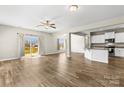Bright open-concept living area features wood floors and a sliding glass door leading to the deck at 2504 Hovis Rd, Lincolnton, NC 28092
