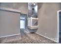 A light-filled living room featuring carpet and a staircase with white railing at 3258 Summercroft Ln, Charlotte, NC 28269