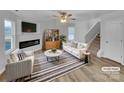 Bright living room with a fireplace, ceiling fan, and stylish decor for comfortable living at 352 Anvil Draw Pl, Rock Hill, SC 29730