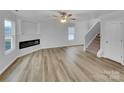 Spacious living room featuring sleek floors, a modern fireplace, and ample natural light at 352 Anvil Draw Pl, Rock Hill, SC 29730