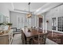 Traditional dining room with wooden floors, custom lighting and access to the foyer at 3608 Mcpherson St, Waxhaw, NC 28173