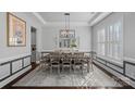 Formal dining room featuring modern chandelier, decorative mirror and neutral decor at 3608 Mcpherson St, Waxhaw, NC 28173