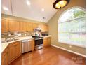 Bright kitchen boasts wood floors, stainless steel appliances, and ample natural light at 4580 Antelope Ln, Charlotte, NC 28269