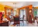 Dining room with a round wood table and chairs, complemented by a china cabinet and natural light at 4811 Spring Lake Dr # C, Charlotte, NC 28212