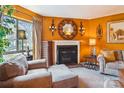 Inviting living room featuring a fireplace, a large window, and comfortable seating in a cozy setting at 4811 Spring Lake Dr # C, Charlotte, NC 28212