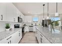 Bright kitchen features white cabinets, granite countertops, stainless appliances, and an island at 6117 Grove Park Blvd, Charlotte, NC 28215