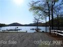 Scenic view of a boat ramp leading to a serene lake with docks and boats at 630 Pinelake Dr, Troy, NC 27371