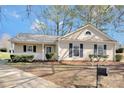 Attractive single-story home with manicured lawn, covered porch, and dark shutters, showcasing curb appeal at 8701 Gainsford Ct, Charlotte, NC 28210