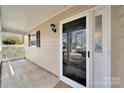 A welcoming front porch featuring a screen door, sidelight, and neutral color scheme at 8701 Gainsford Ct, Charlotte, NC 28210