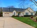 View of a single Gathering home showing the driveway, and well-maintained landscaping at 8723 Totteridge Dr, Charlotte, NC 28277