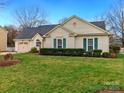 Well-kept single-story home with green shutters and a tidy front lawn at 8723 Totteridge Dr, Charlotte, NC 28277