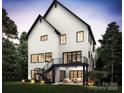 Spacious backyard features a modern white home with black trim, a balcony, and a staircase at 910 Laurel Creek Ln, Charlotte, NC 28211