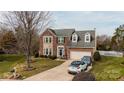 Traditional two-story brick home with dormers, two-car garage, and well-maintained landscaping at 11307 Celandine Ct, Charlotte, NC 28213