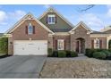 Charming home with a brick and stone facade, two-car garage, and well-maintained landscaping at 119 Front Porch Dr # 46, Rock Hill, SC 29732