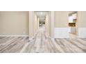 Bright hallway with light gray flooring, and white trim, leading to a bright, open living space at 119 Front Porch Dr # 46, Rock Hill, SC 29732