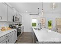 Bright, modern kitchen with quartz countertops, stainless appliances, and grey cabinets at 119 Stonewater Dr # 22, Red Cross, NC 28129